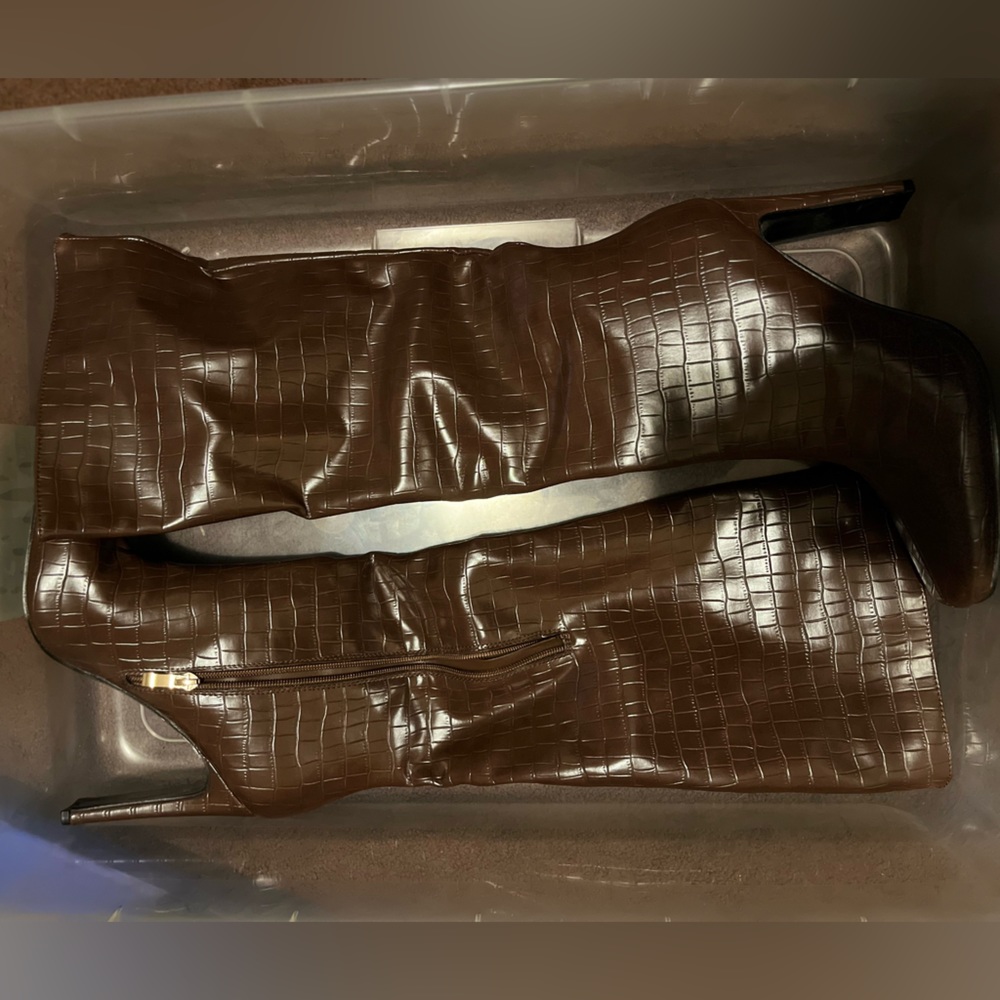 Brown knee high. High heeled boots.